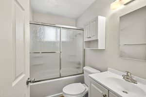 Bathroom with glass shower door, white cabinets at Lincoln Court Townhomes, 230 Lincoln Street, Fairview, Oregon 97024