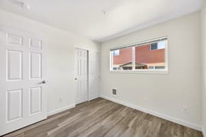 Bedroom with laminate flooring, large window at Lincoln Court Townhomes, 230 Lincoln Street, Fairview, Oregon 97024