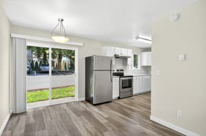 Modern apartment kitchen with stainless steel appliances at Lincoln Court in Fairview, Oregon