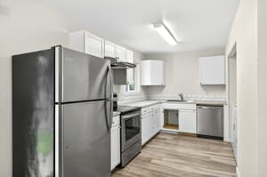 Kitchen with stainless steel appliances, white cabinets at Lincoln Court Townhomes, 230 Lincoln Street, Fairview, Oregon 97024