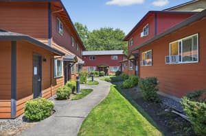 Exterior with red siding, landscaped pathway at Lincoln Court Townhomes, 230 Lincoln Street, Fairview, Oregon 97024