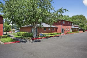Exterior with red siding, landscaped garden at Lincoln Court Townhomes, 230 Lincoln Street, Fairview, Oregon 97024