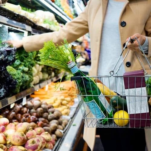 Shopper selecting fresh produce at a grocery store